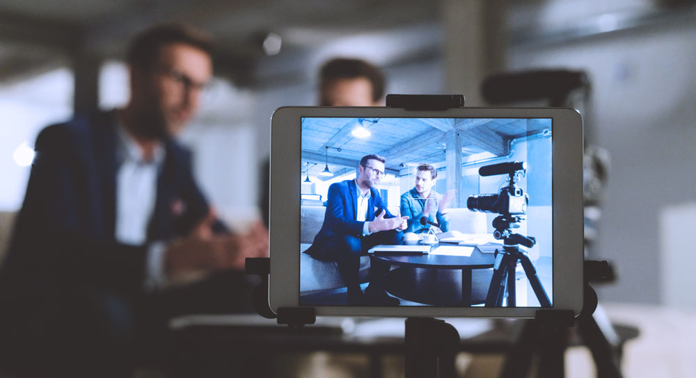a view through camera lens of two men talking