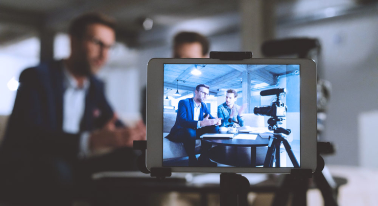 a view through camera lens of two men talking 